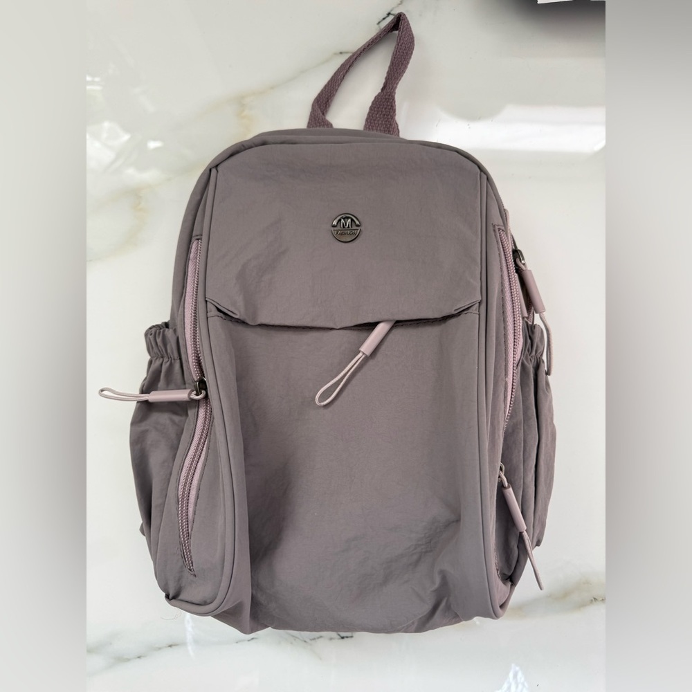 Gray Backpack With Multiple Pockets - image 1